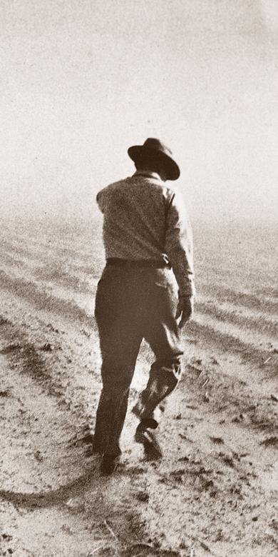 Ezra Taft Benson inspecting a farm during a drought